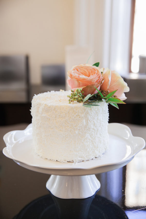 Simple sprinkles and fresh flowers pair for a sophisticated, textural tower cake.