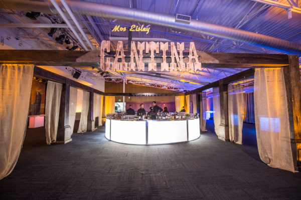 A custom-built bar space with a made-to-order structure and Cantina sign.